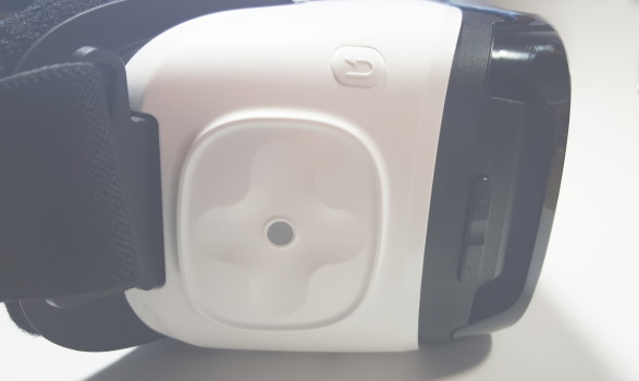 Gear VR controls: touchpad, white back button above touchpad, black volume button to right.