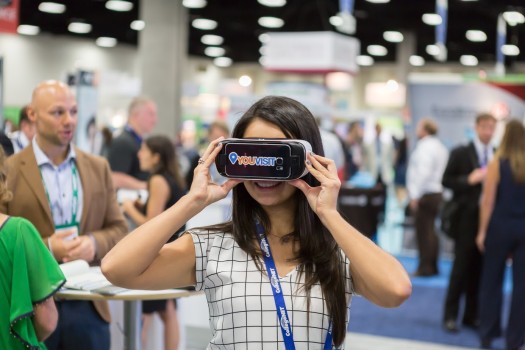 Woman views YouVisit VR experience through Gear VR headsets. (Image courtesy YouVisit.)