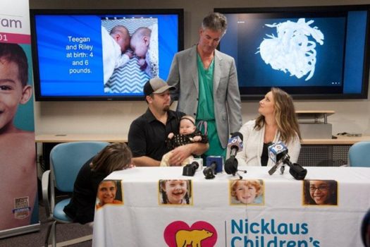 Dr. Burke with Cassidy and Chad Lexcen, parents of twins Teegan and Riley, as well as Harper, 6 and Asher, 3. (Image courtesy Nicklaus Children's Hospital.)